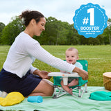 baby and mother in a pop ‘n sit portable booster seat