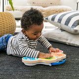 baby playing with a magic touch drums wooden musical toy