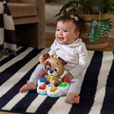 baby playing with a drum & learn dean musical learning toy