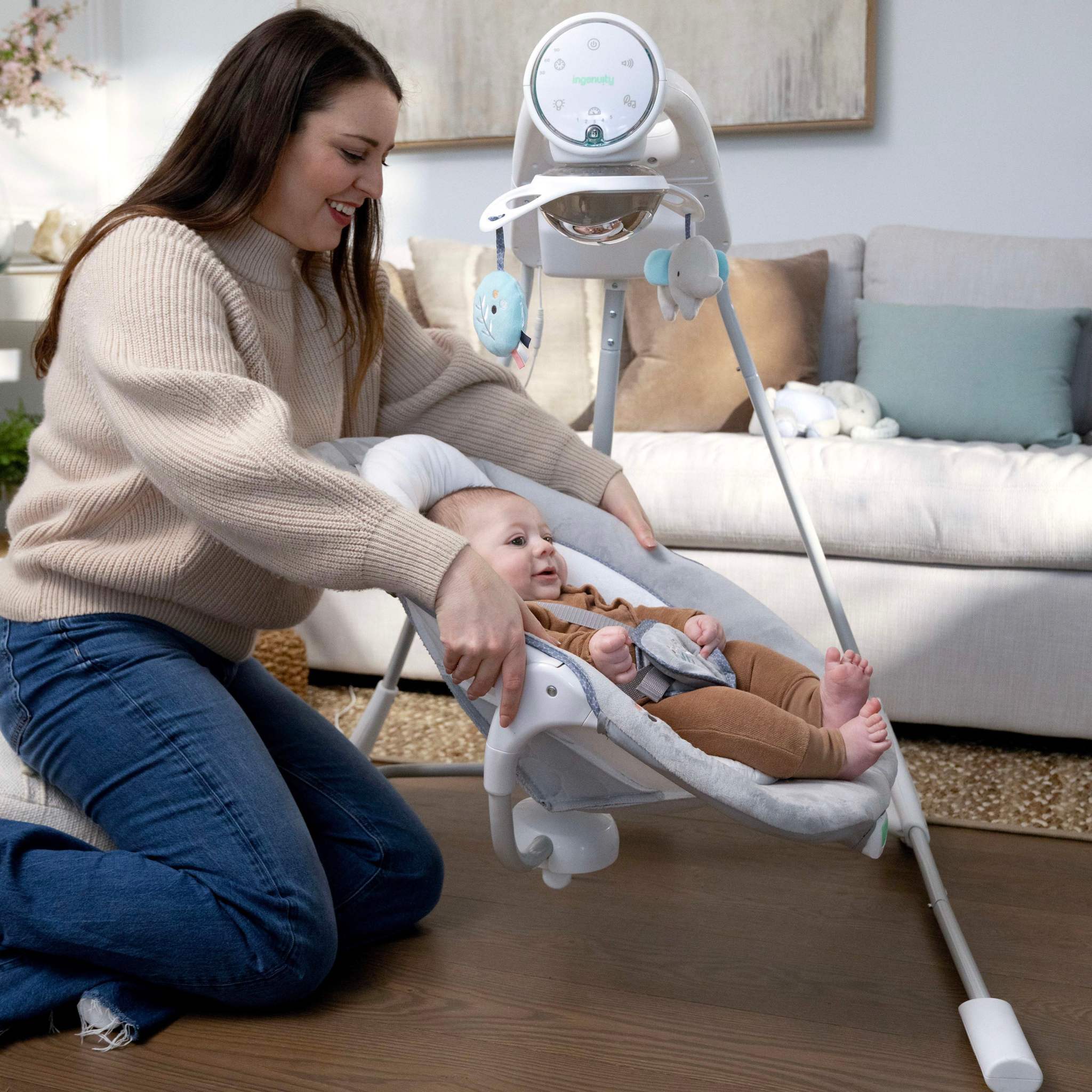 mother with baby in a inlighten soothing swing - dakota