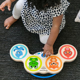 baby playing with a magic touch drums wooden musical toy