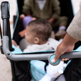 baby in a pop 'n ride stroller wagon