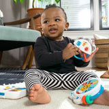 baby playing with a small symphony 3-piece musical toy set