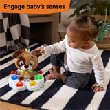 baby playing with a drum & learn dean musical learning toy