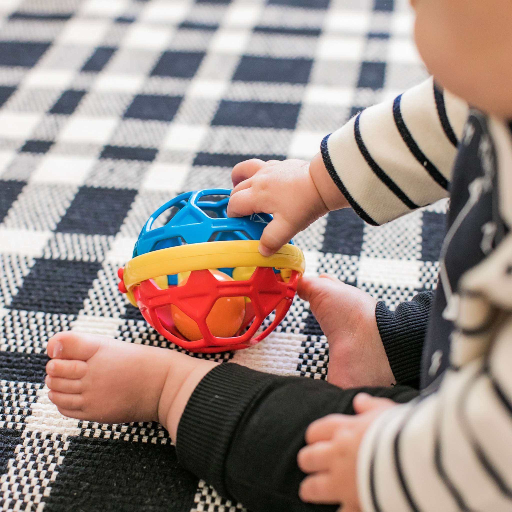Flexible baby sensory rattle ball toy with colorful textures and caterpillar design